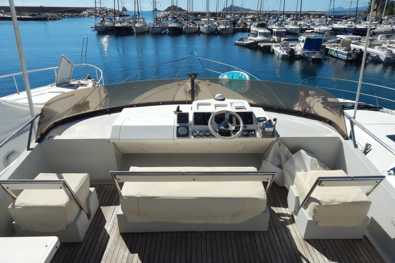 Yacht Photos Pics 1992 Fairline 50 yacht helm with marina view, featuring comfortable seating and navigation controls.