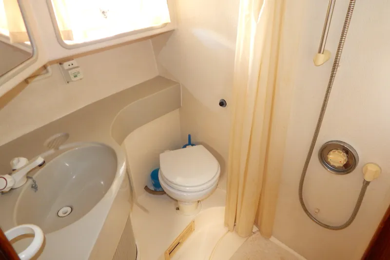  Yacht Photos Pics Bathroom interior of 1992 Fairline 50 yacht with sink, toilet, and shower.