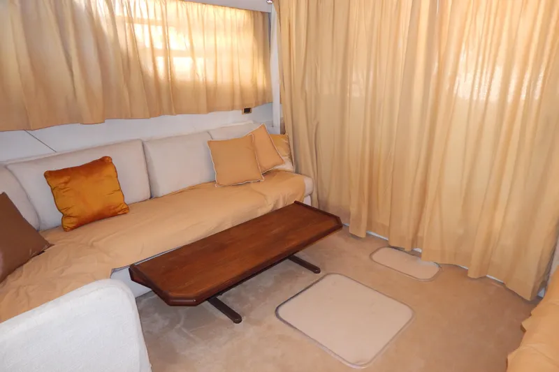  Yacht Photos Pics Cozy interior of 1992 Fairline 50 yacht with beige curtains and cushions.