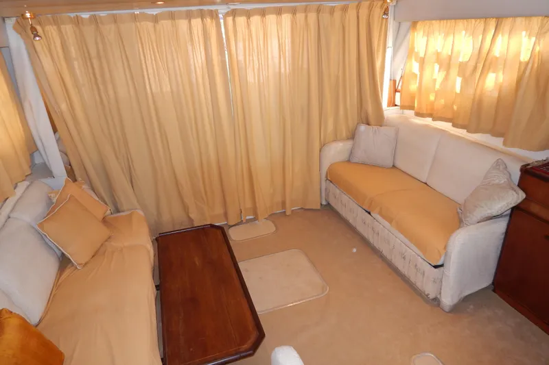  Yacht Photos Pics Interior of 1992 Fairline 50 yacht with beige sofas and curtains.