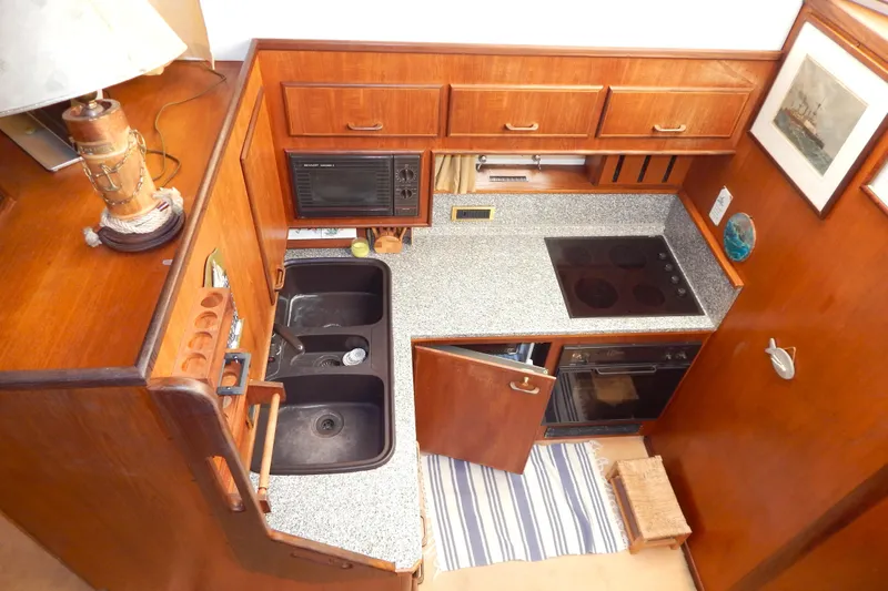  Yacht Photos Pics 1992 Fairline 50 yacht kitchen with wooden cabinets, dual sinks, and modern appliances.