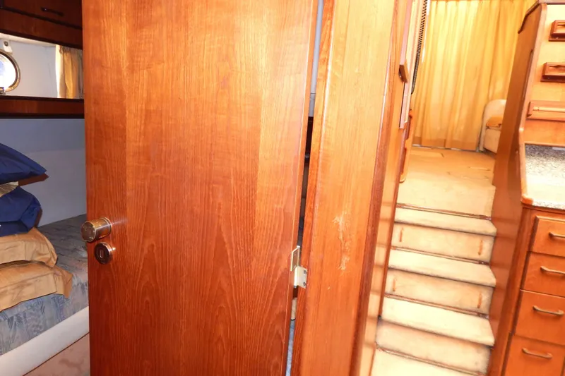  Yacht Photos Pics Interior of 1992 Fairline 50 yacht, featuring wooden door, stairs, and cozy cabin.