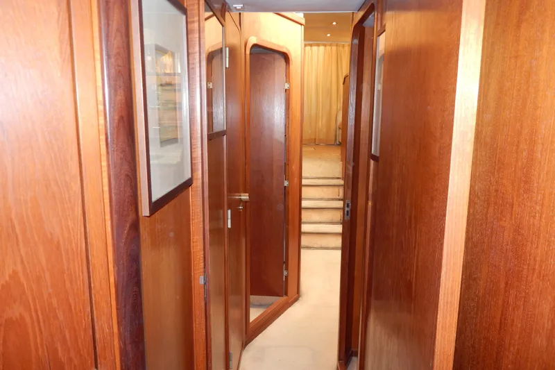  Yacht Photos Pics Interior hallway of 1992 Fairline 50 yacht with wooden paneling and carpeted stairs.