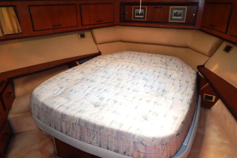  Yacht Photos Pics Luxurious cabin interior of a 1992 Fairline 50 yacht with a cozy bed.