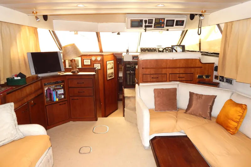  Yacht Photos Pics Luxurious 1992 Fairline 50 yacht interior with cozy seating, wooden cabinetry, and modern amenities.
