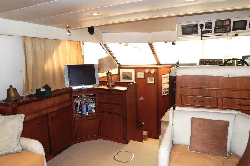  Yacht Photos Pics Interior of 1992 Fairline 50 yacht with wood cabinetry and cozy seating area.