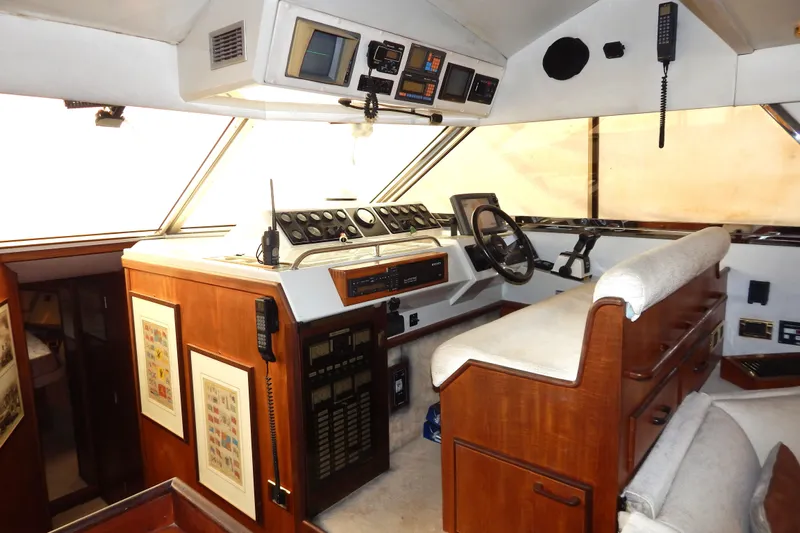  Yacht Photos Pics Interior of a 1992 Fairline 50 yacht cockpit with navigation instruments and wooden finish.