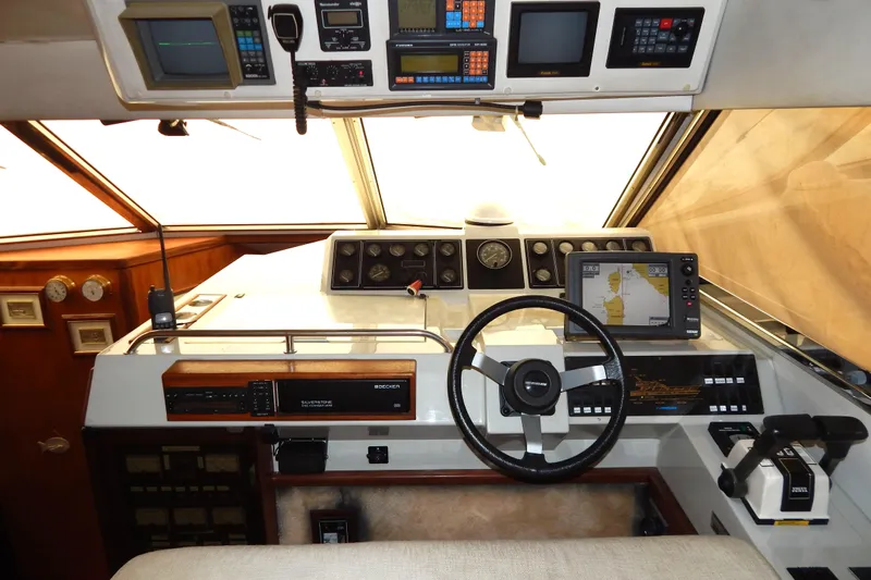  Yacht Photos Pics Cockpit of a 1992 Fairline 50 yacht with navigation instruments and steering wheel.