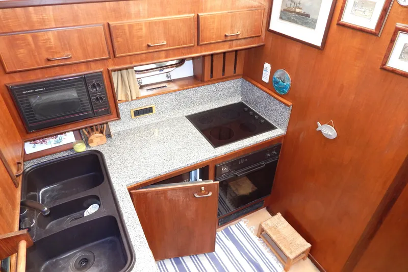  Yacht Photos Pics 1992 Fairline 50 yacht kitchen with wooden cabinets, granite countertop, and modern appliances.