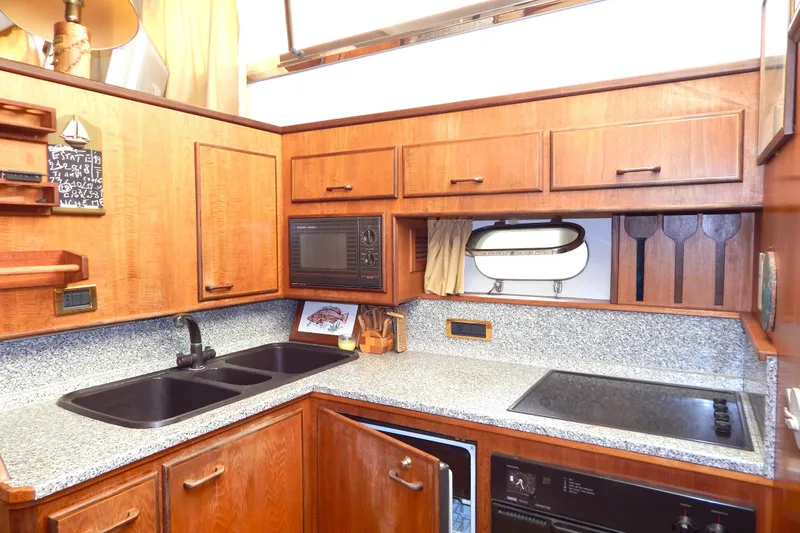  Yacht Photos Pics Luxurious 1992 Fairline 50 yacht kitchen with wooden cabinets and modern appliances.