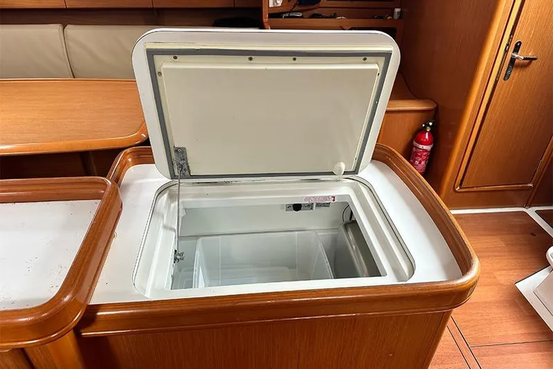  Yacht Photos Pics Open fridge in 2007 Beneteau Cyclades 50 yacht interior, wooden finish.