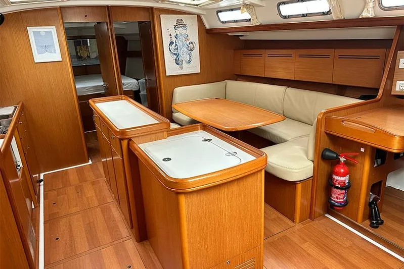  Yacht Photos Pics Interior of 2007 Beneteau Cyclades 50 yacht with wood finish and cozy seating area.