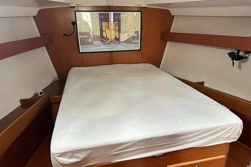  Yacht Photos Pics Interior cabin of 2007 Beneteau Cyclades 50 yacht with bed and wooden finish.