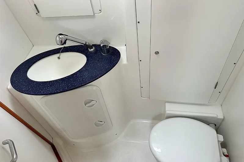  Yacht Photos Pics Beneteau Cyclades 50 2007 yacht bathroom with sink and toilet, compact and modern design.