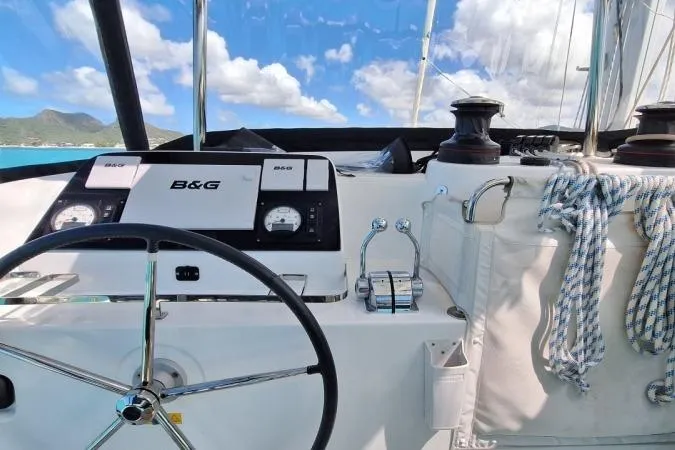 Total Eclipse Yacht Photos Pics Cockpit of 2018 Lagoon 42 catamaran with steering wheel and navigation instruments.