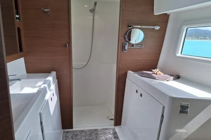 Total Eclipse Yacht Photos Pics Modern bathroom interior of 2018 Lagoon 42 yacht with shower and vanity.