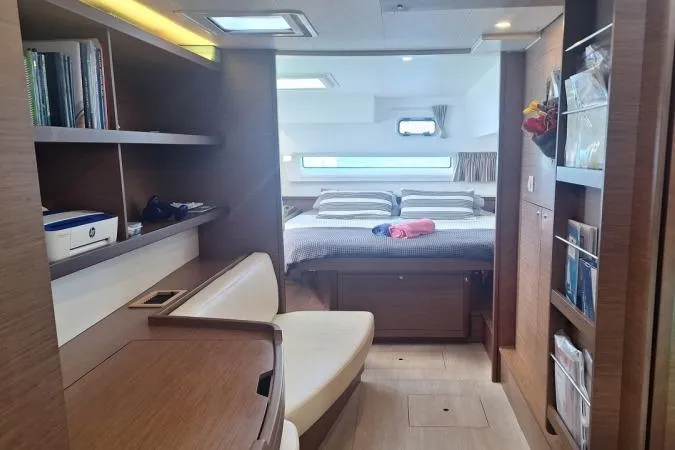 Total Eclipse Yacht Photos Pics Luxurious interior of a 2018 Lagoon 42 catamaran with cozy bedroom and modern furnishings.