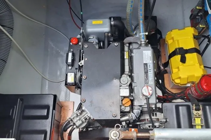 Total Eclipse Yacht Photos Pics Engine compartment of a 2018 Lagoon 42 catamaran, showcasing mechanical components and wiring.