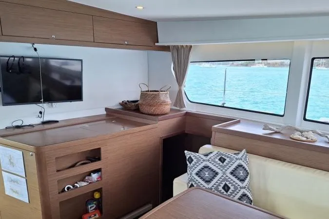 Total Eclipse Yacht Photos Pics Interior of 2018 Lagoon 42 catamaran with modern furnishings and ocean view.