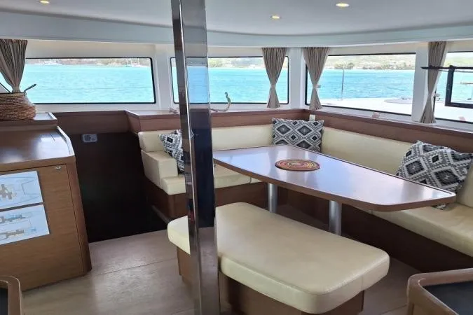 Total Eclipse Yacht Photos Pics Interior of 2018 Lagoon 42 catamaran with dining area and ocean view.