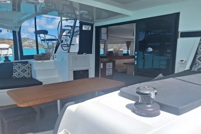 Total Eclipse Yacht Photos Pics Interior view of 2018 Lagoon 42 catamaran, featuring spacious seating and modern design.