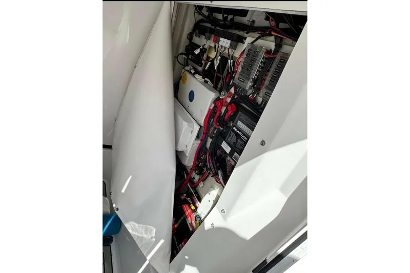  Yacht Photos Pics 2023 Sportsman Masters 267 Bay Boat electrical compartment with wiring and components.