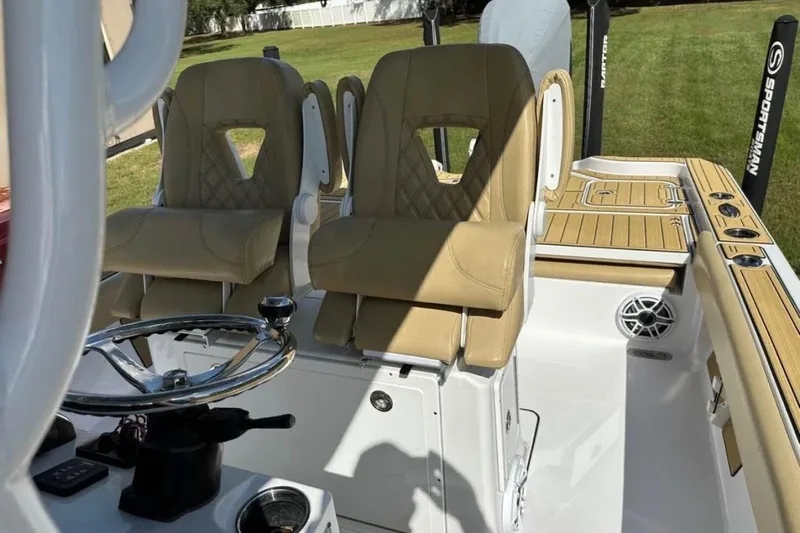  Yacht Photos Pics 2023 Sportsman Masters 267 Bay Boat interior with tan seats and steering wheel.