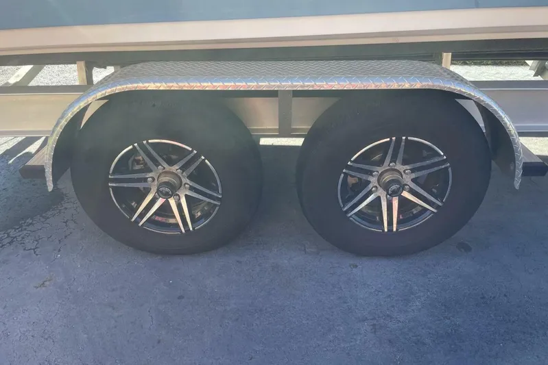  Yacht Photos Pics 2023 Sportsman Masters 267 Bay Boat trailer wheels with chrome rims and diamond plate fender.