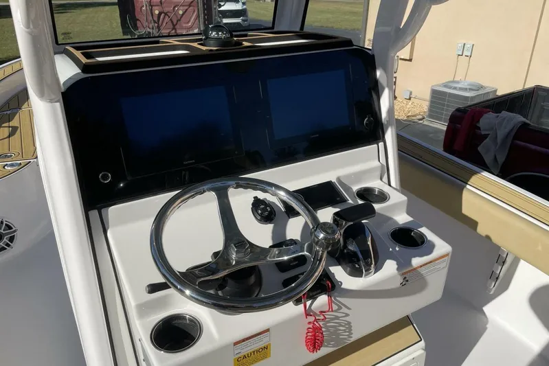  Yacht Photos Pics 2023 Sportsman Masters 267 Bay Boat dashboard with steering wheel and controls.