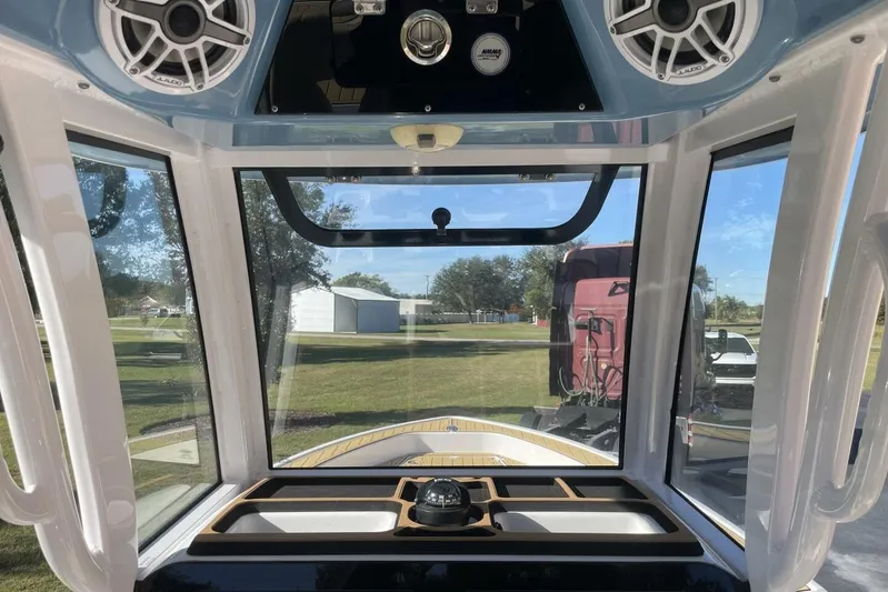  Yacht Photos Pics 2023 Sportsman Masters 267 Bay Boat interior with speakers and windshield view.