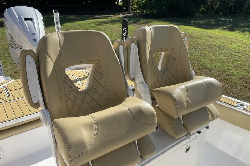  Yacht Photos Pics 2023 Sportsman Masters 267 Bay Boat seats with tan upholstery and diamond stitching.