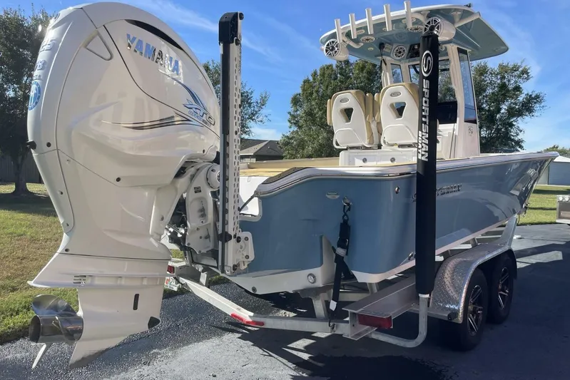  Yacht Photos Pics 2023 Sportsman Masters 267 Bay Boat with Yamaha engine on trailer, parked outdoors.