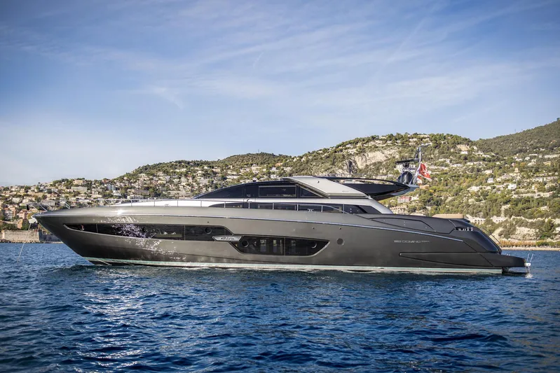 Yacht Photos Pics 2019 Riva 88 Domino Super yacht cruising on blue waters near a scenic coastline.