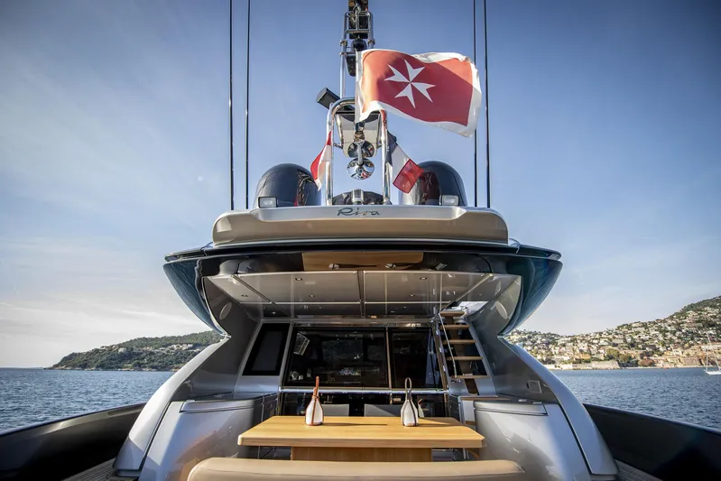  Yacht Photos Pics 2019 Riva 88 Domino Super yacht with flags, docked in scenic coastal waters.
