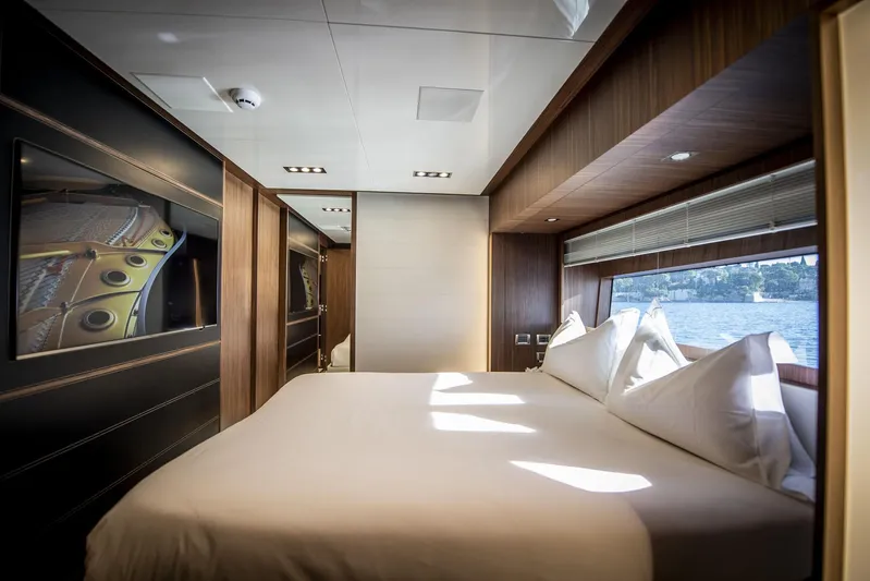  Yacht Photos Pics Luxurious bedroom interior of 2019 Riva 88 Domino Super yacht with elegant wood finishes.