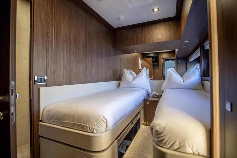  Yacht Photos Pics Luxurious twin cabin interior on 2019 Riva 88 Domino Super yacht, featuring elegant wood paneling.