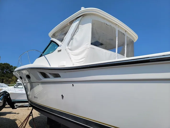  Yacht Photos Pics 2006 Tiara Yachts 3200 Open boat with white exterior, docked under clear blue sky.