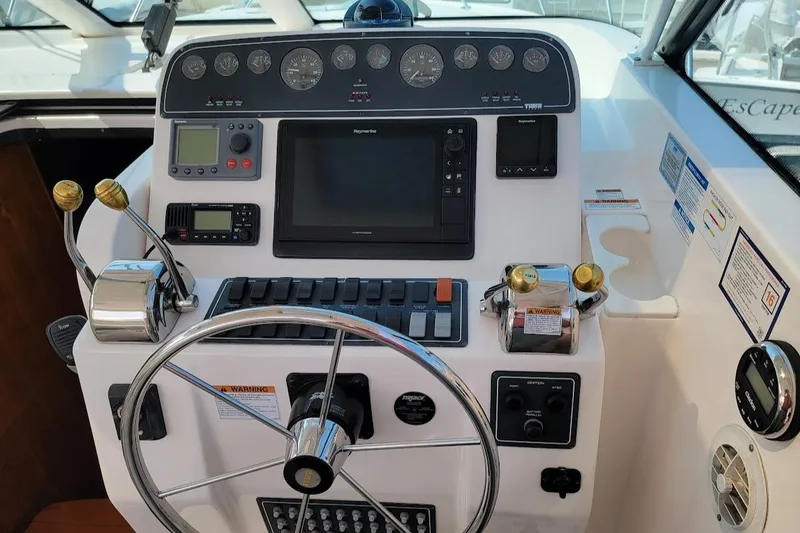  Yacht Photos Pics 2006 Tiara Yachts 3200 Open helm with navigation controls and steering wheel.