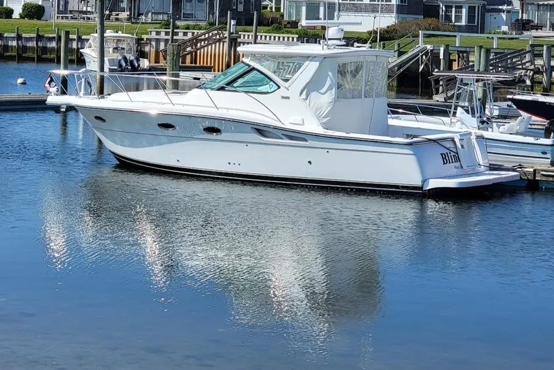  Yacht Photos Pics 2006 Tiara Yachts 3200 Open docked in a serene marina setting.