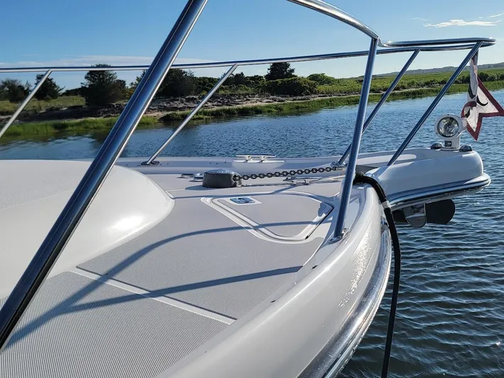  Yacht Photos Pics 2006 Tiara Yachts 3200 Open on calm water, showcasing sleek deck design.