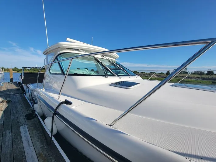  Yacht Photos Pics 2006 Tiara Yachts 3200 Open docked, showcasing sleek design and clear blue sky.