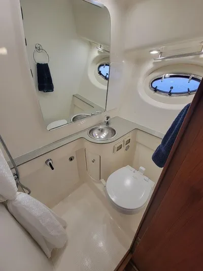  Yacht Photos Pics 2006 Tiara Yachts 3200 Open bathroom with sink, mirror, and porthole window.
