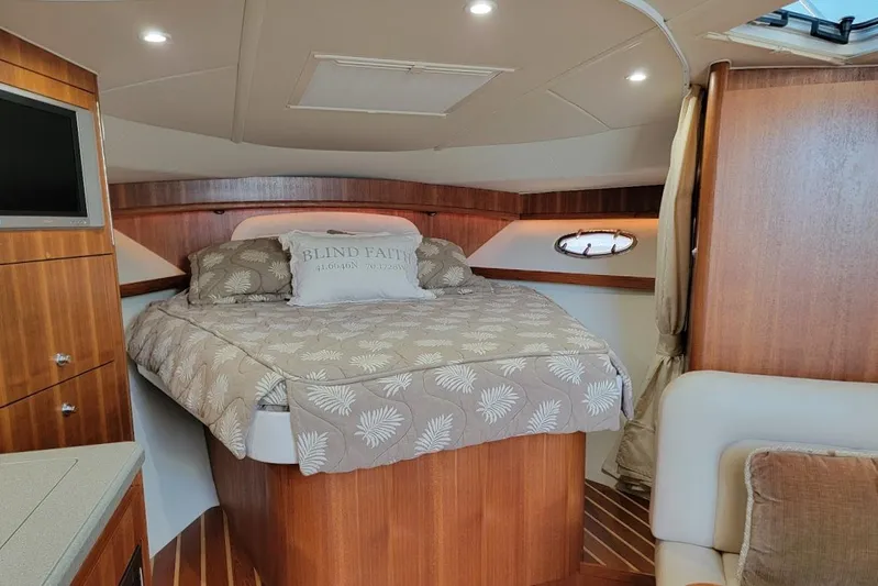  Yacht Photos Pics Luxurious cabin interior of 2006 Tiara Yachts 3200 Open with cozy bed and wood finish.