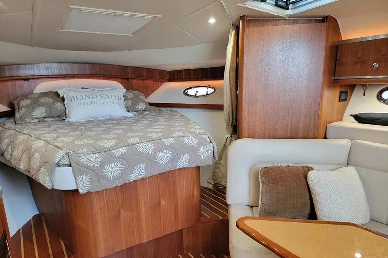  Yacht Photos Pics Luxurious 2006 Tiara Yachts 3200 Open cabin interior with cozy bed and elegant wood finish.
