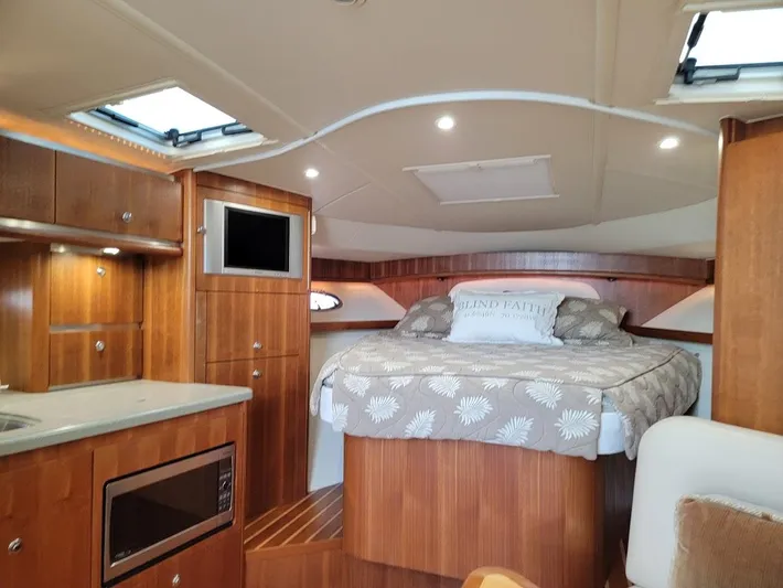 Yacht Photos Pics Interior of 2006 Tiara Yachts 3200 Open, featuring cozy cabin with bed and kitchenette.