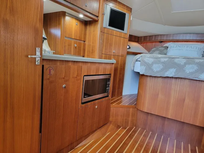  Yacht Photos Pics 2006 Tiara Yachts 3200 Open interior with wood finish, kitchenette, and cozy sleeping area.