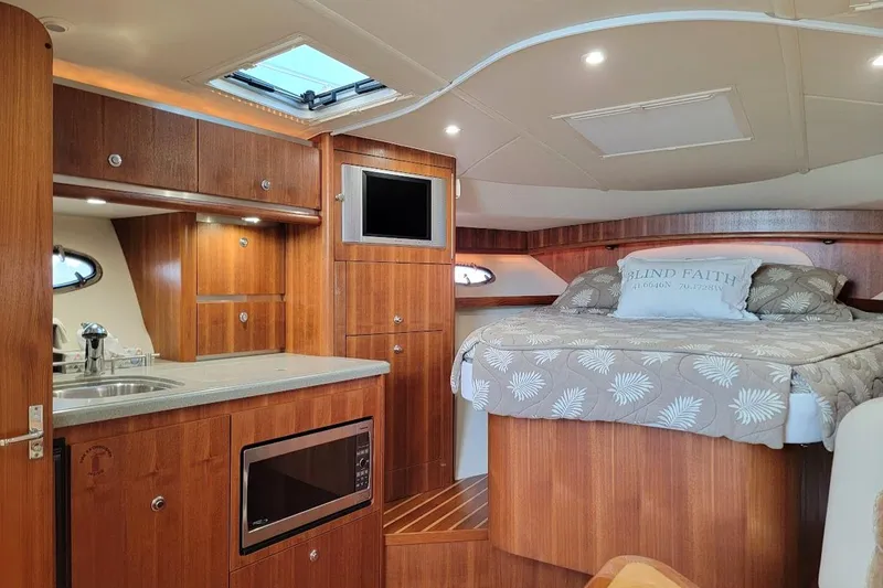  Yacht Photos Pics 2006 Tiara Yachts 3200 Open interior with bed, kitchenette, and wood finish.