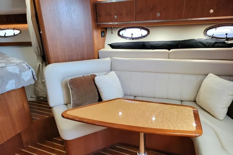  Yacht Photos Pics 2006 Tiara Yachts 3200 Open interior with cozy seating and elegant wood finishes.