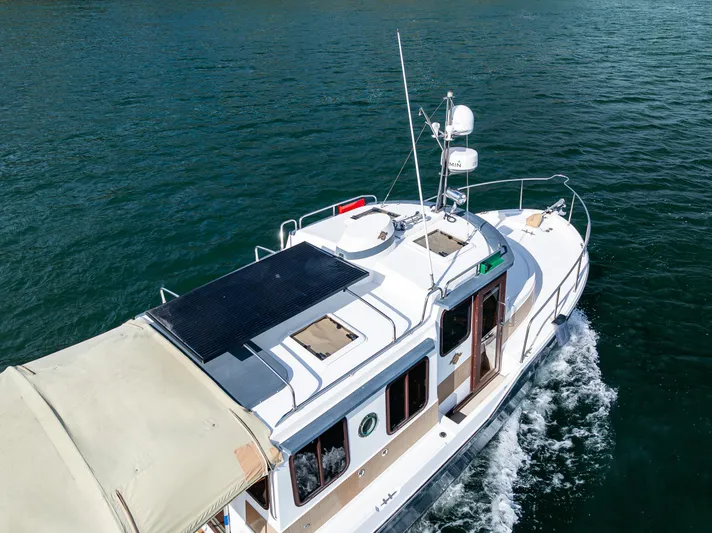 Caldonia Yacht Photos Pics 2013 Ranger Tugs R 29 cruising on open water, aerial view.
