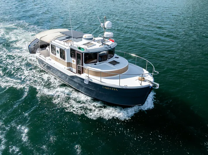 Caldonia Yacht Photos Pics 2013 Ranger Tugs R 29 cruising on open water, aerial view.